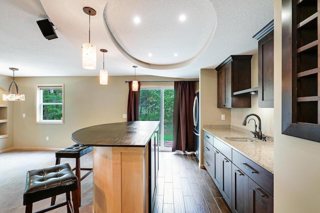 22669 128th Ave N, Rogers, MN 55374 - kitchen with a sink, healthy amount of natural light, a kitchen island, a textured ceiling, and freestanding refrigerator