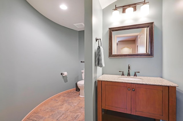 22669 128th Ave N, Rogers, MN 55374 - half bath featuring stone finish flooring, toilet, baseboards, and vanity