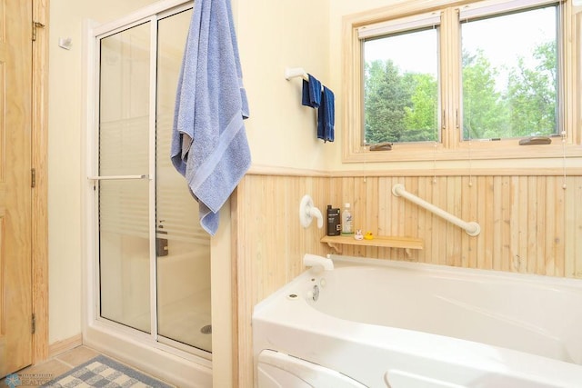 38682 Walker Lake Dr, Amor Twp, MN 56576 - full bath with a stall shower, a garden tub, wainscoting, tile patterned flooring, and wooden walls