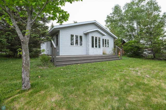 38682 Walker Lake Dr, Amor Twp, MN 56576 - rear view of house featuring a lawn and a deck