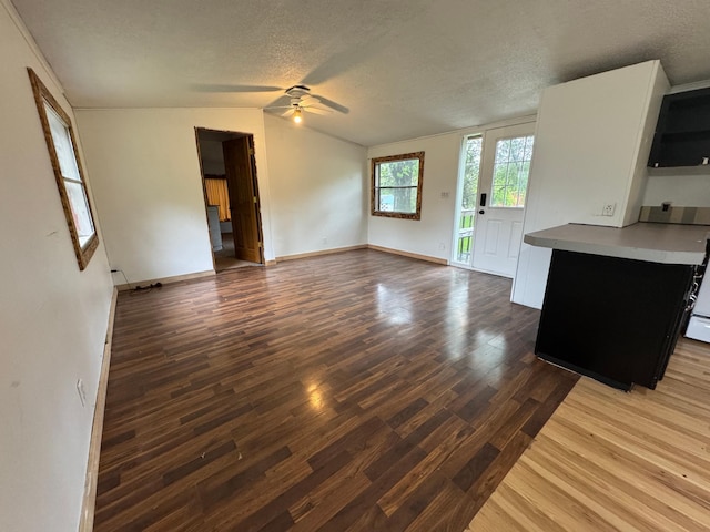 57230 351st St, Grove City, MN 56243 - unfurnished living room with ceiling fan, a textured ceiling, wood finished floors, and baseboards