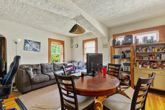410 Spruce Ave NW, Montgomery, MN 56069 - dining space featuring a textured wall, a textured ceiling, and wood finished floors