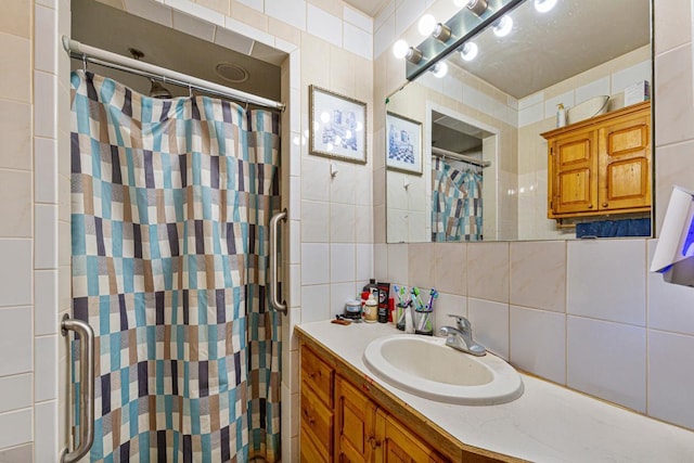 410 Spruce Ave NW, Montgomery, MN 56069 - bathroom featuring tile walls, decorative backsplash, curtained shower, and vanity