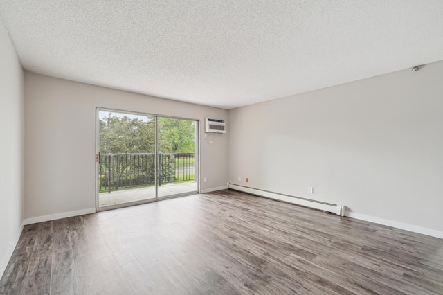 4351 Parklawn Ave Unit 105E, Edina, MN 55435 - empty room with a baseboard radiator, wood finished floors, a textured ceiling, an AC wall unit, and baseboards
