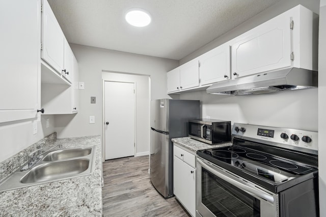 4351 Parklawn Ave Unit 105E, Edina, MN 55435 - kitchen with stainless steel appliances, under cabinet range hood, a sink, and white cabinetry