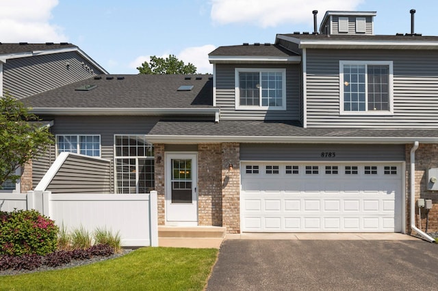 8783 Hastings Cir NE, Blaine, MN 55449 - view of front facade featuring asphalt driveway, an attached garage, and roof with shingles