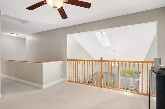 8783 Hastings Cir NE, Blaine, MN 55449 - hall featuring a skylight, carpet, and baseboards