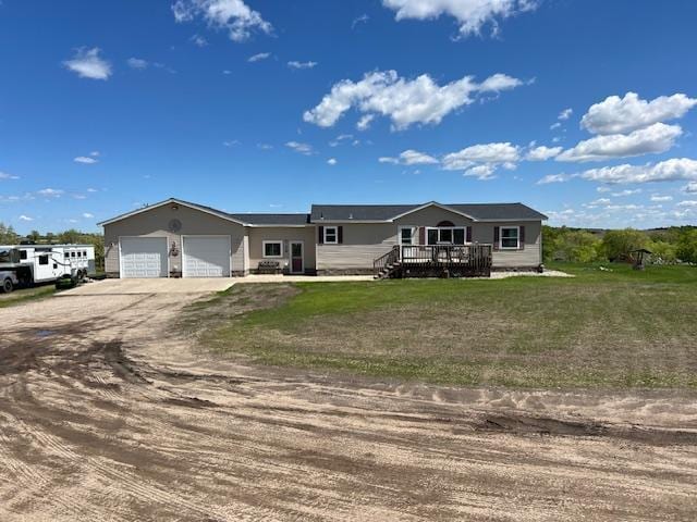 42626 County Highway 125, Perham Twp, MN 56573 - view of front of house featuring dirt driveway, an attached garage, a wooden deck, and a front lawn