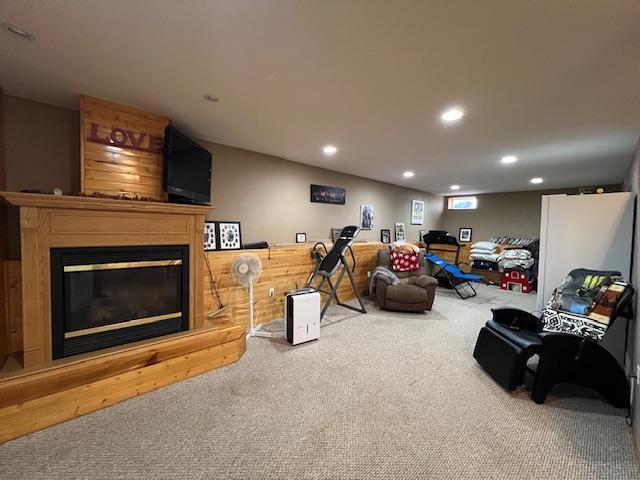42626 County Highway 125, Perham Twp, MN 56573 - living area featuring carpet floors, a glass covered fireplace, and recessed lighting