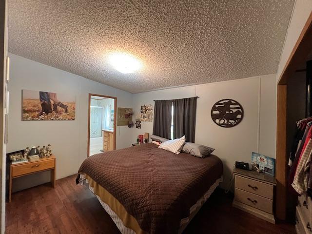 42626 County Highway 125, Perham Twp, MN 56573 - bedroom with a textured ceiling, dark wood-type flooring, and vaulted ceiling
