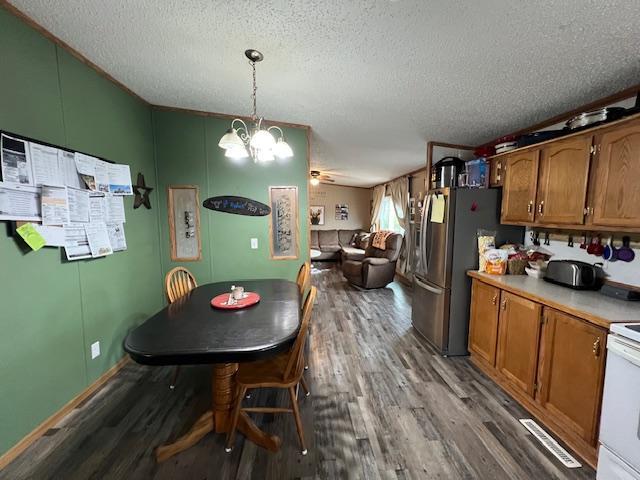 42626 County Highway 125, Perham Twp, MN 56573 - dining room with wood finished floors, a textured ceiling, and a chandelier