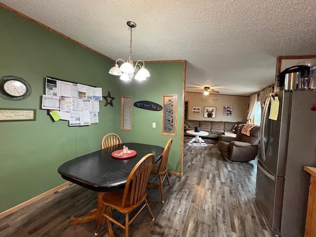 42626 County Highway 125, Perham Twp, MN 56573 - dining room with wood finished floors, a textured ceiling, a chandelier, a ceiling fan, and baseboards