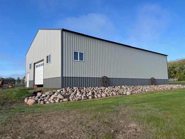 42626 County Highway 125, Perham Twp, MN 56573 - view of side of property featuring a garage, an outbuilding, and a yard