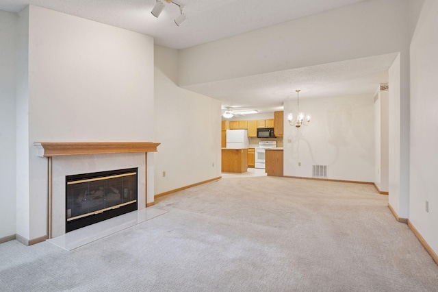 8733 Baxter Way Unit 47, Inver Grove Heights, MN 55076 - unfurnished living room with light colored carpet, a glass covered fireplace, and a chandelier