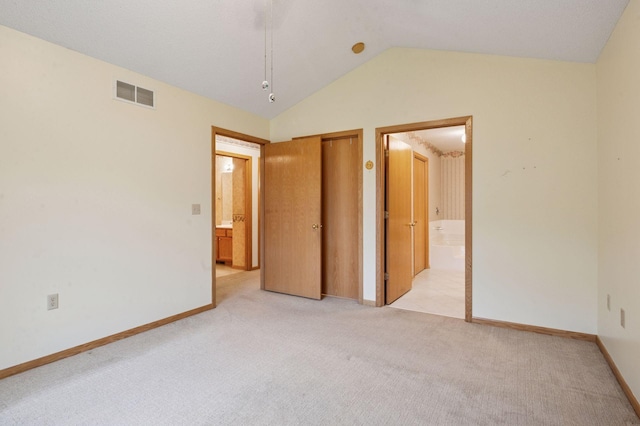 8733 Baxter Way Unit 47, Inver Grove Heights, MN 55076 - unfurnished bedroom featuring light colored carpet, vaulted ceiling, ensuite bath, and a closet