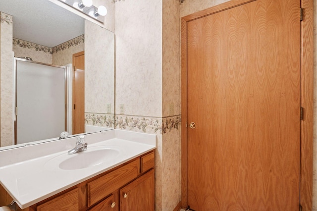 8733 Baxter Way Unit 47, Inver Grove Heights, MN 55076 - bathroom featuring wallpapered walls, vanity, and a shower stall
