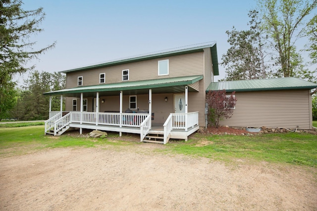 642 4th St, Turtle Lake, WI 54004 - view of front of property with metal roof, a porch, and a front lawn
