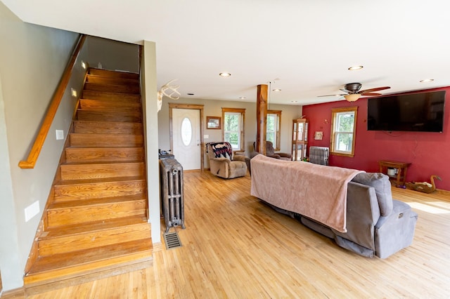 642 4th St, Turtle Lake, WI 54004 - living room with light wood finished floors, stairway, recessed lighting, a ceiling fan, and radiator