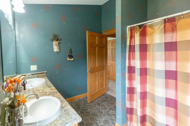 642 4th St, Turtle Lake, WI 54004 - bathroom with double vanity, a shower with curtain, and baseboards