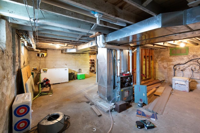 642 4th St, Turtle Lake, WI 54004 - unfinished below grade area featuring fridge and heating unit