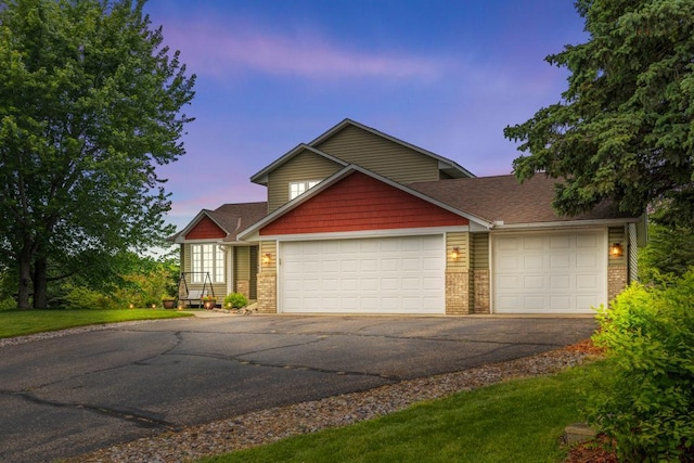 1279 146th Ln NW, Andover, MN 55304 - view of front facade featuring asphalt driveway, a garage, and brick siding