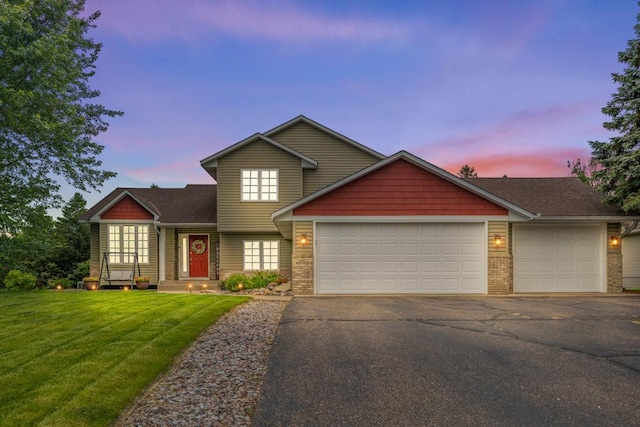 1279 146th Ln NW, Andover, MN 55304 - view of front of house with a garage, a front yard, asphalt driveway, and brick siding