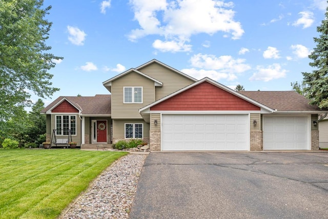 1279 146th Ln NW, Andover, MN 55304 - view of front of home featuring a garage, driveway, a front yard, roof with shingles, and brick siding