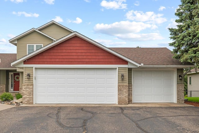 1279 146th Ln NW, Andover, MN 55304 - view of front of property with driveway, brick siding, and an attached garage