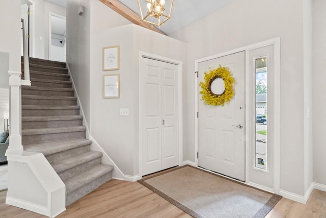 1279 146th Ln NW, Andover, MN 55304 - entryway with light wood-style floors, stairway, a chandelier, and baseboards