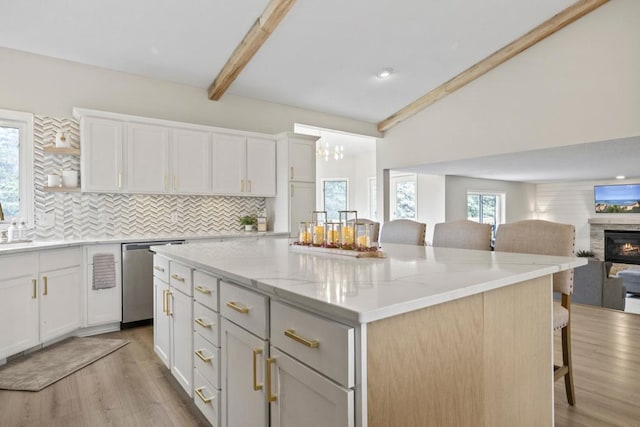 1279 146th Ln NW, Andover, MN 55304 - kitchen featuring dishwasher, a breakfast bar area, open floor plan, and backsplash