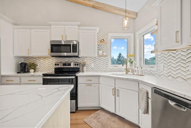 1279 146th Ln NW, Andover, MN 55304 - kitchen with stainless steel appliances, a sink, white cabinets, backsplash, and hanging light fixtures