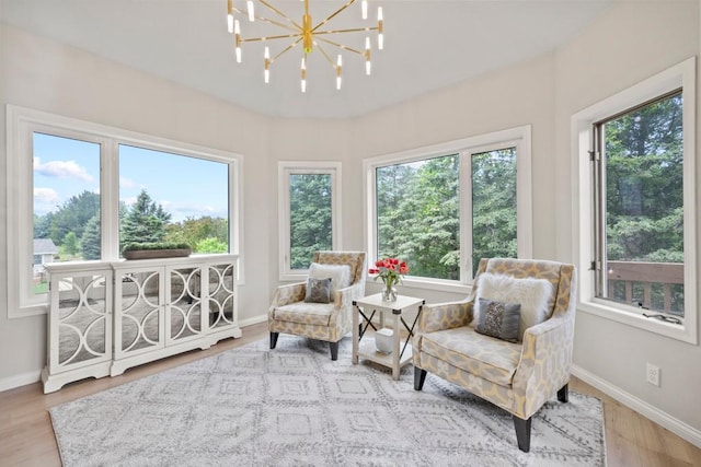 1279 146th Ln NW, Andover, MN 55304 - sunroom / solarium with wood finished floors, healthy amount of natural light, baseboards, and a chandelier