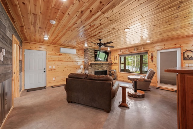 52852 Brush Shanty Lake Rd, Bigfork, MN 56628 - living room with a fireplace, ceiling fan, wooden walls, wooden ceiling, and finished concrete flooring