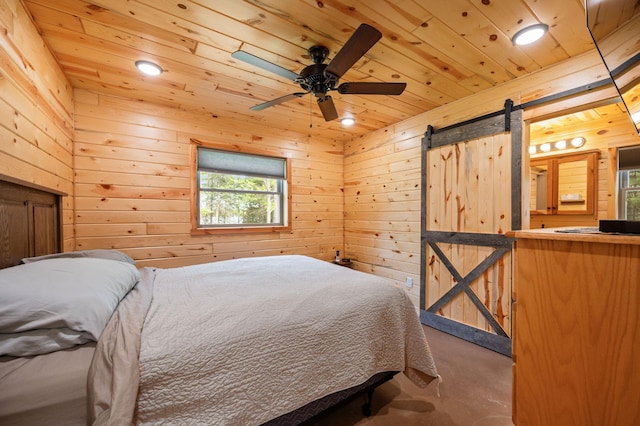 52852 Brush Shanty Lake Rd, Bigfork, MN 56628 - bedroom with a barn door, wood ceiling, wood walls, multiple windows, and concrete flooring