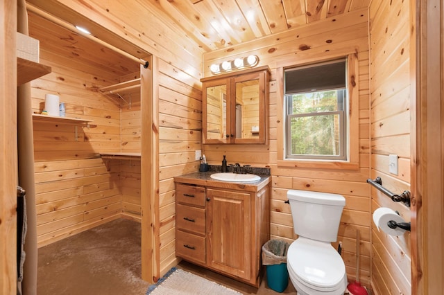 52852 Brush Shanty Lake Rd, Bigfork, MN 56628 - bathroom featuring wood walls, vanity, toilet, finished concrete floors, and wooden ceiling