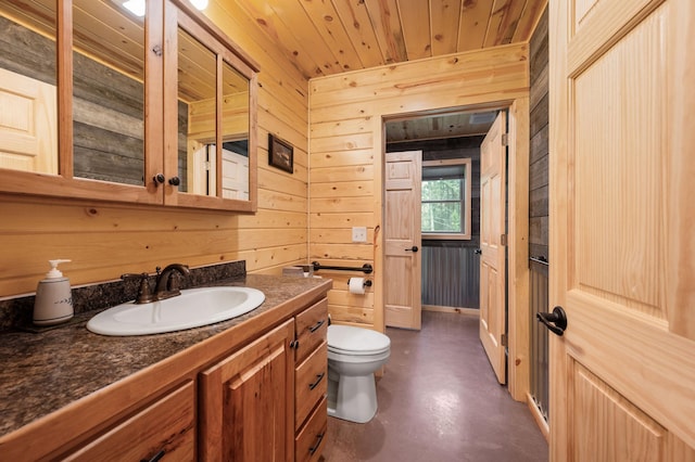 52852 Brush Shanty Lake Rd, Bigfork, MN 56628 - bathroom featuring wood walls, concrete flooring, vanity, toilet, and wood ceiling