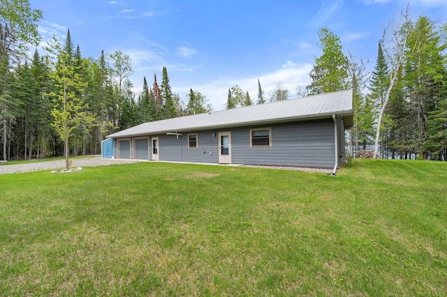 52852 Brush Shanty Lake Rd, Bigfork, MN 56628 - rear view of property with a garage, a yard, and driveway