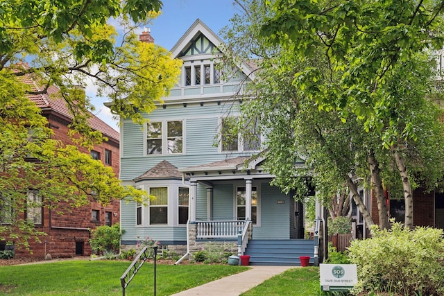 776 Summit Ave, Saint Paul, MN 55105 - view of front of house with a porch, a front lawn, and a shingled roof