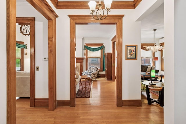 776 Summit Ave, Saint Paul, MN 55105 - hall with a chandelier, wood finished floors, ornamental molding, and plenty of natural light