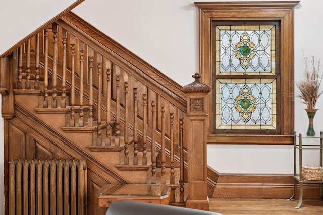 776 Summit Ave, Saint Paul, MN 55105 - stairway with radiator heating unit and wood finished floors