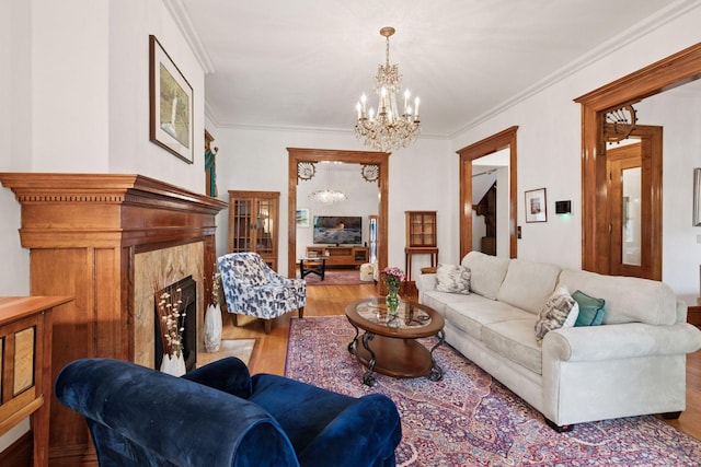 776 Summit Ave, Saint Paul, MN 55105 - living room featuring a chandelier, wood finished floors, a premium fireplace, and ornamental molding