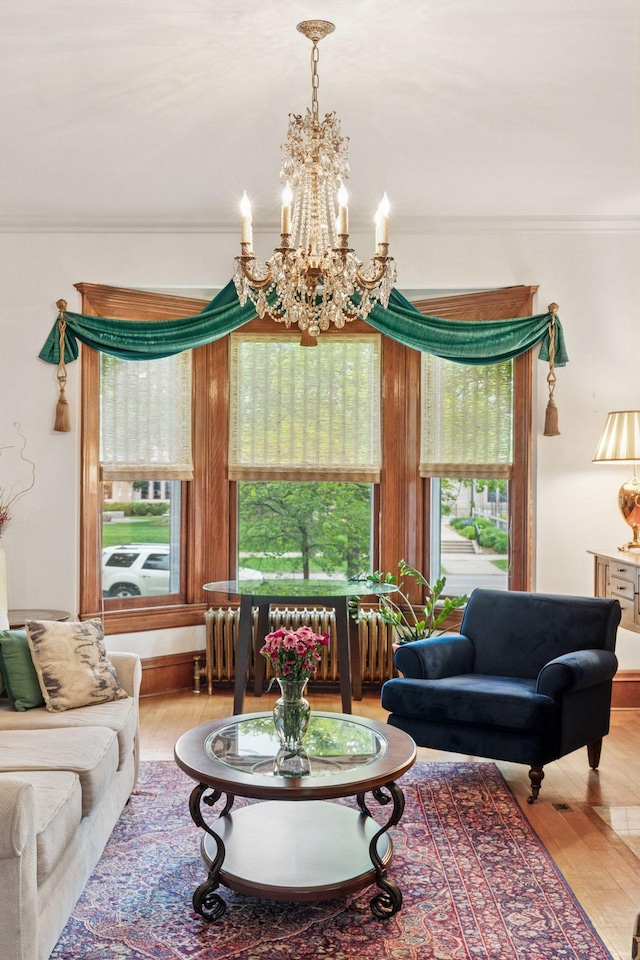 776 Summit Ave, Saint Paul, MN 55105 - living room featuring ornamental molding, wood finished floors, and a chandelier
