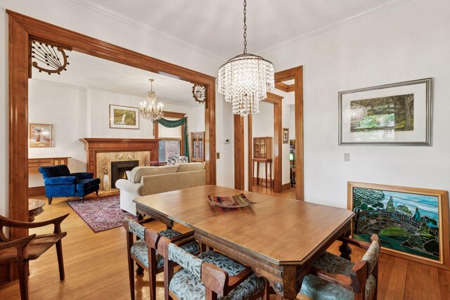776 Summit Ave, Saint Paul, MN 55105 - dining room featuring a chandelier, ornamental molding, light wood finished floors, and a high end fireplace