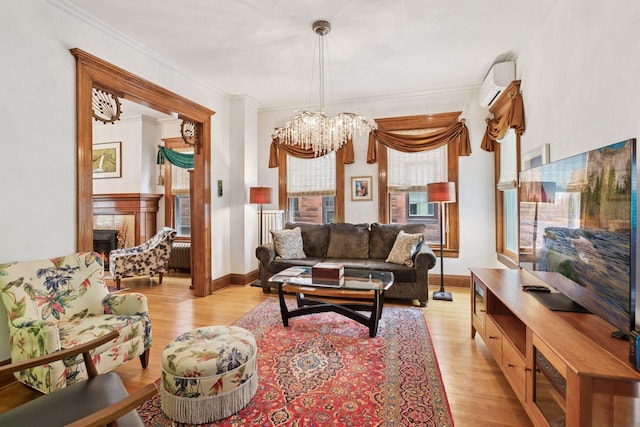 776 Summit Ave, Saint Paul, MN 55105 - living room featuring a wall mounted air conditioner, light wood-style flooring, ornamental molding, a chandelier, and a premium fireplace