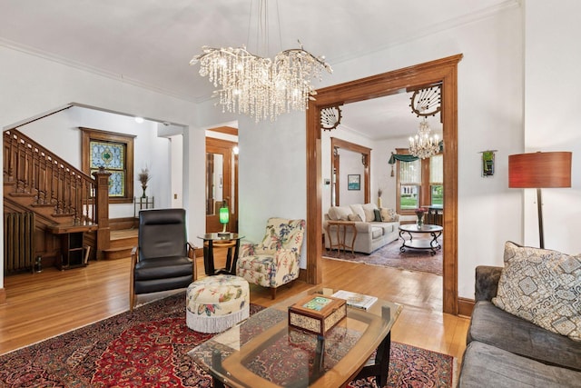776 Summit Ave, Saint Paul, MN 55105 - living room with a chandelier, crown molding, stairs, and wood finished floors
