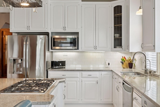 776 Summit Ave, Saint Paul, MN 55105 - kitchen with appliances with stainless steel finishes, white cabinetry, glass insert cabinets, and backsplash
