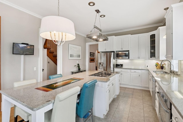 776 Summit Ave, Saint Paul, MN 55105 - kitchen with appliances with stainless steel finishes, ornamental molding, decorative backsplash, a center island, and white cabinets