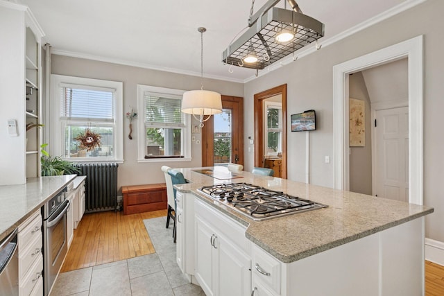 776 Summit Ave, Saint Paul, MN 55105 - kitchen featuring appliances with stainless steel finishes, radiator, ornamental molding, white cabinetry, and light stone counters