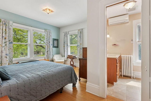 776 Summit Ave, Saint Paul, MN 55105 - bedroom with radiator heating unit, an AC wall unit, and light wood finished floors