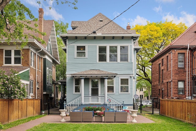 776 Summit Ave, Saint Paul, MN 55105 - back of house with a shingled roof, an outdoor living space, and a chimney